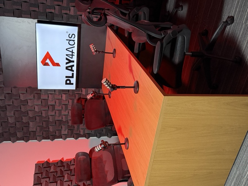 Mesa do podcast com microfones e logo PLAY4Ads